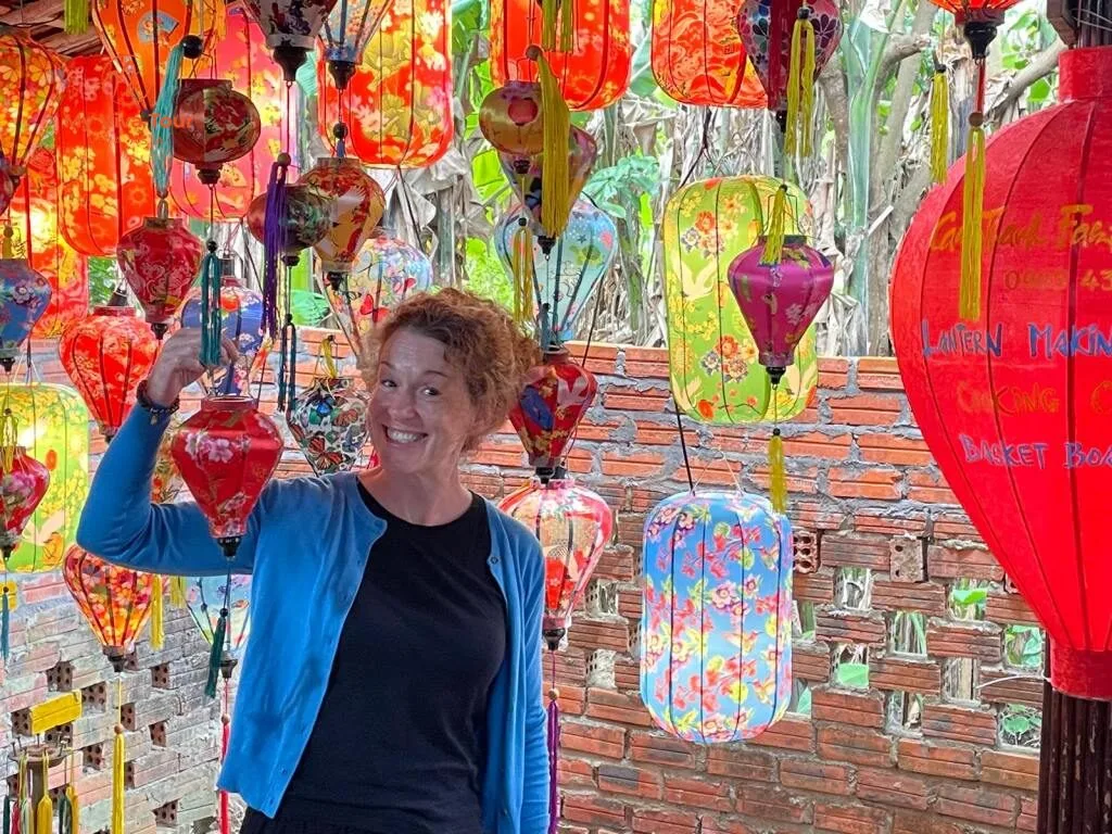 Clare holding a silk lantern at a lantern-making workshop in Hoi An, Vietnam