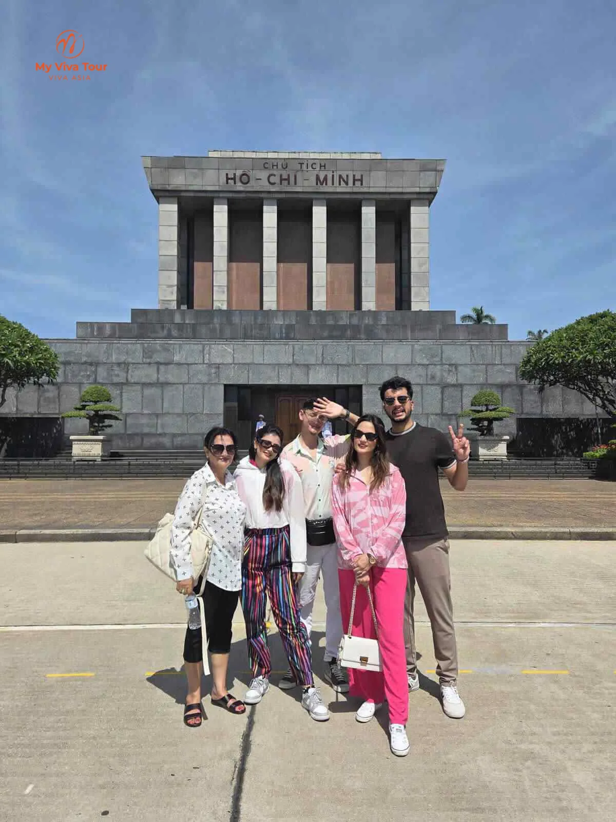 Family of five in front of Ho Chi Minh Mausoleum in Hanoi