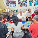 Karen Dieu's Vietnam trip group making red silk lanterns at a Hoi An workshop