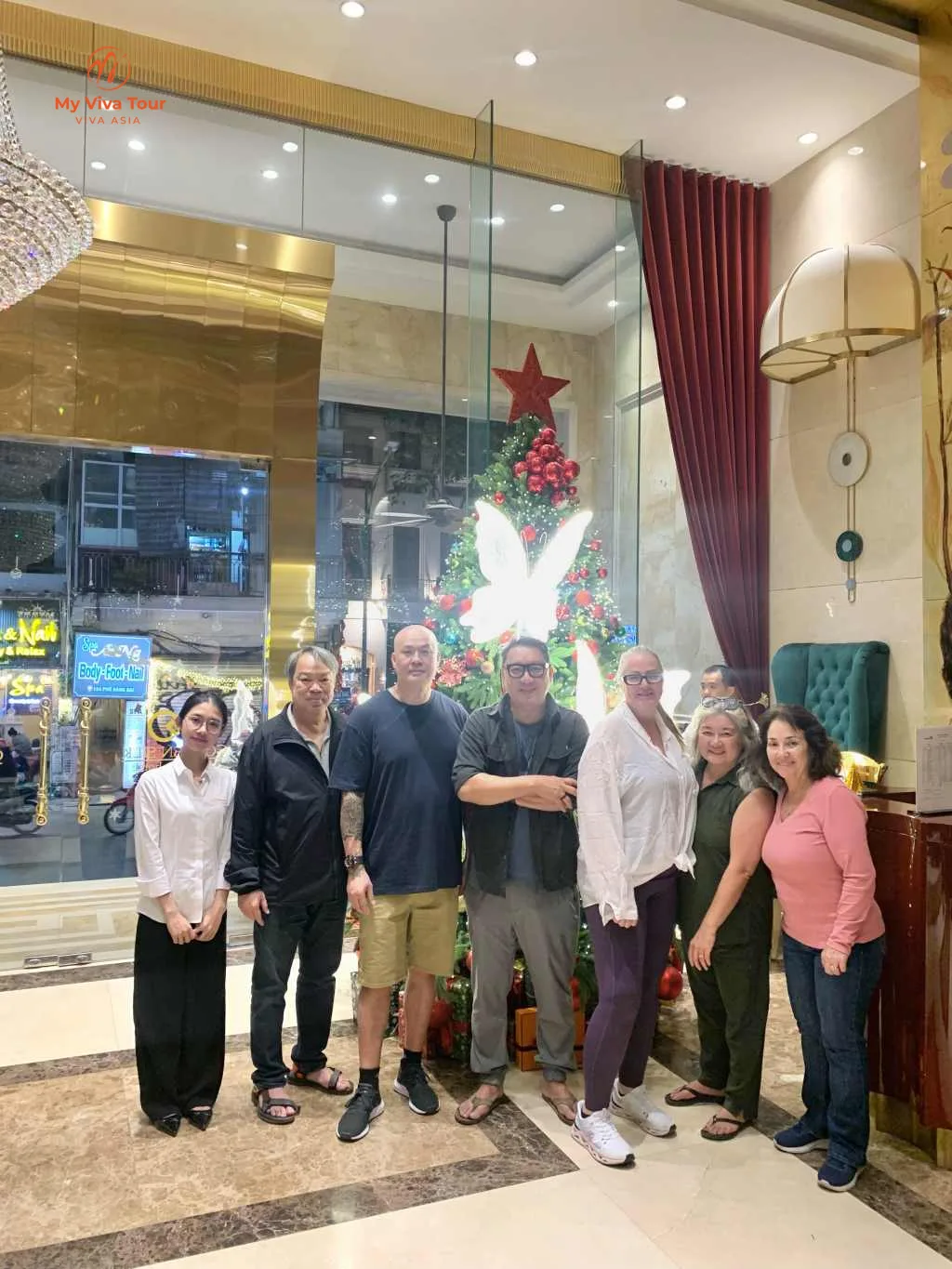 Karen Dieu and friends together at their Hanoi hotel by a Christmas tree in December