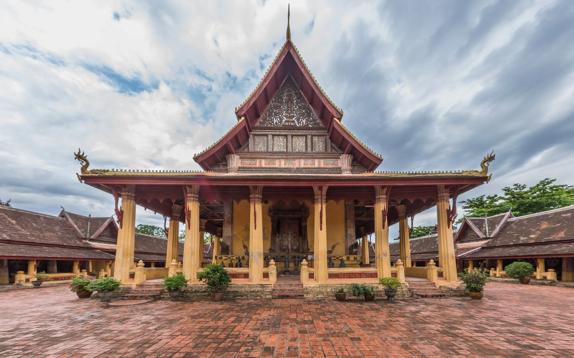 Wat Si Saket temple and its tiered roof in Vientiane, Laos, seen across the brick courtyard