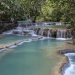 Luang Prabang travel guide — turquoise tiered pools of Kuang Si Falls in the jungle