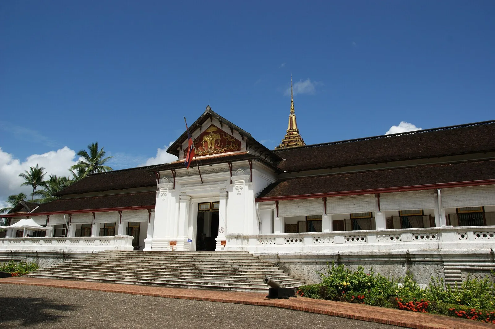White facade and gilded Lao spire of the Royal Palace Haw Kham, now the Luang Prabang National Museum