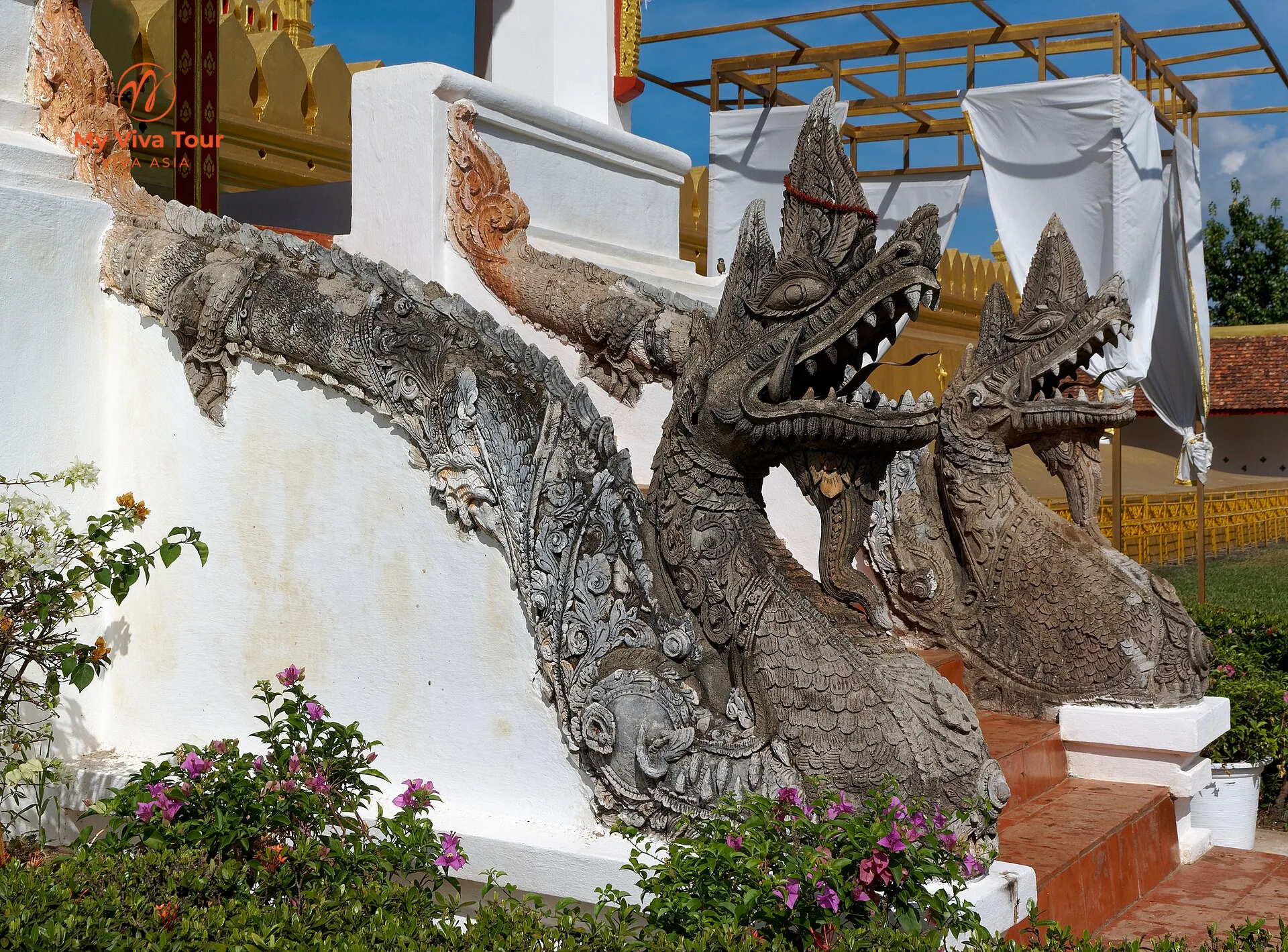 Carved stone naga serpent balustrades at the base of Pha That Luang in Vientiane