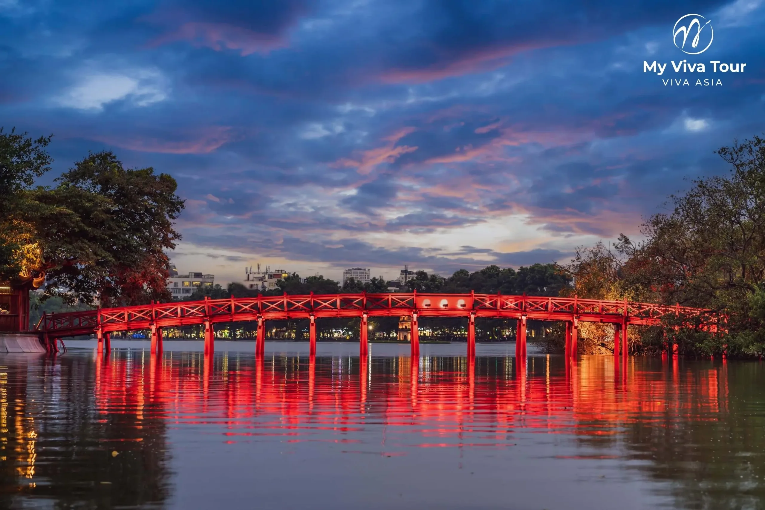 The Huc Bridge over Hoan Kiem Lake in Hanoi at dusk, arriving in Vietnam