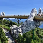 The Golden Bridge held by giant stone hands at Ba Na Hills, Da Nang, Vietnam