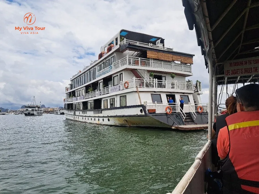 Boarding a white overnight cruise boat on Ha Long Bay, Vietnam