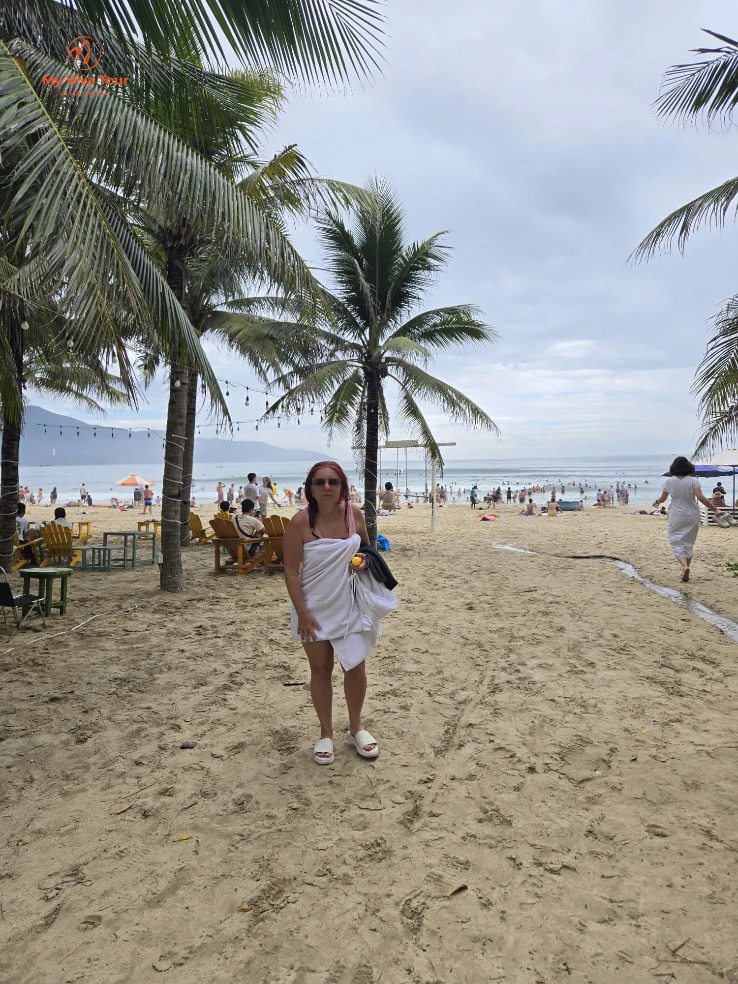 Traveller wrapped in a towel after a sunrise swim at Da Nang beach
