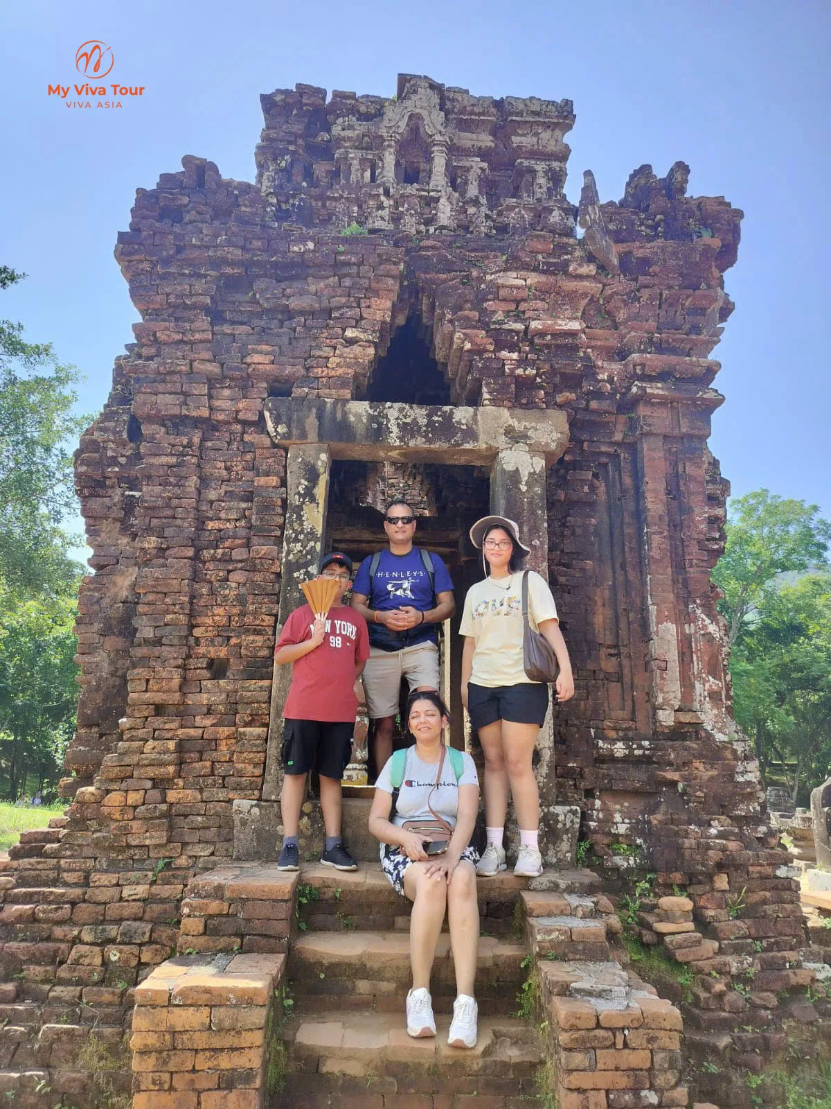 Hanoi to Da Nang family trip: Vikram's family of four on the steps of a Cham brick tower at My Son Sanctuary