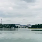 Da Lat travel guide: Xuan Huong Lake with the Da Lat cityscape and hilltop tower behind it