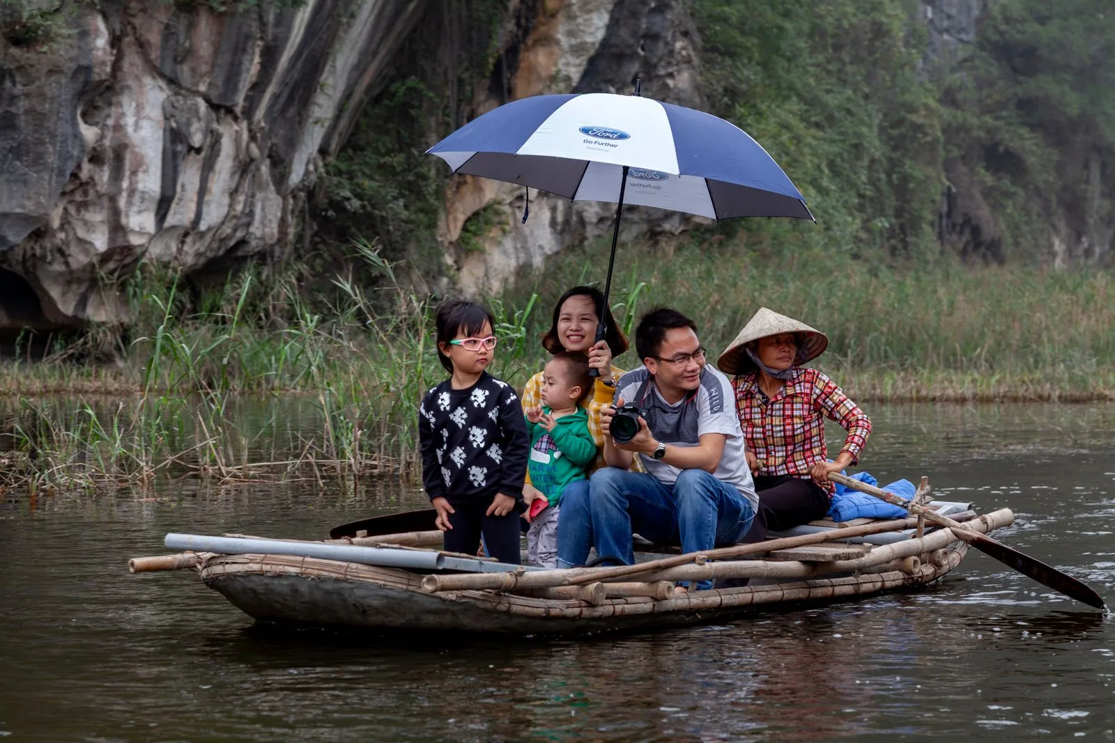 Family taking a boat ride through the Vietnam countryside