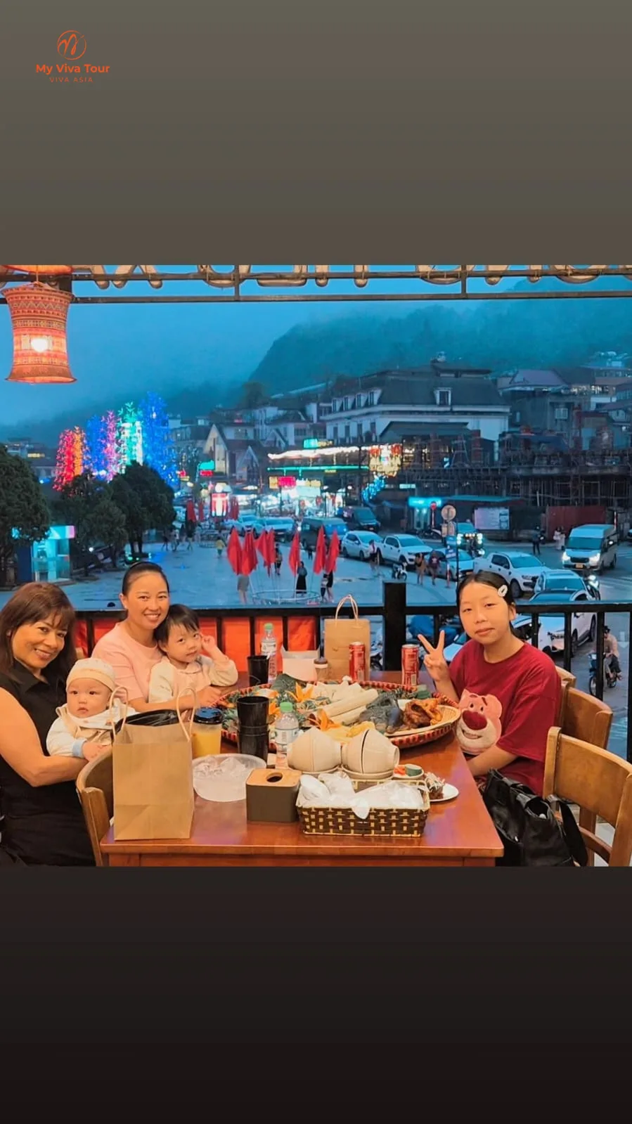 Farida at dinner on a balcony overlooking Sapa town at dusk