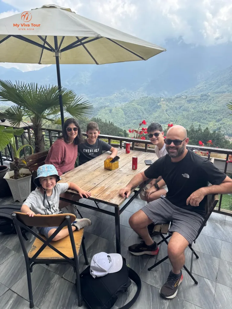 Family trip to Sapa lunch overlooking misty rice terrace mountains, Vietnam