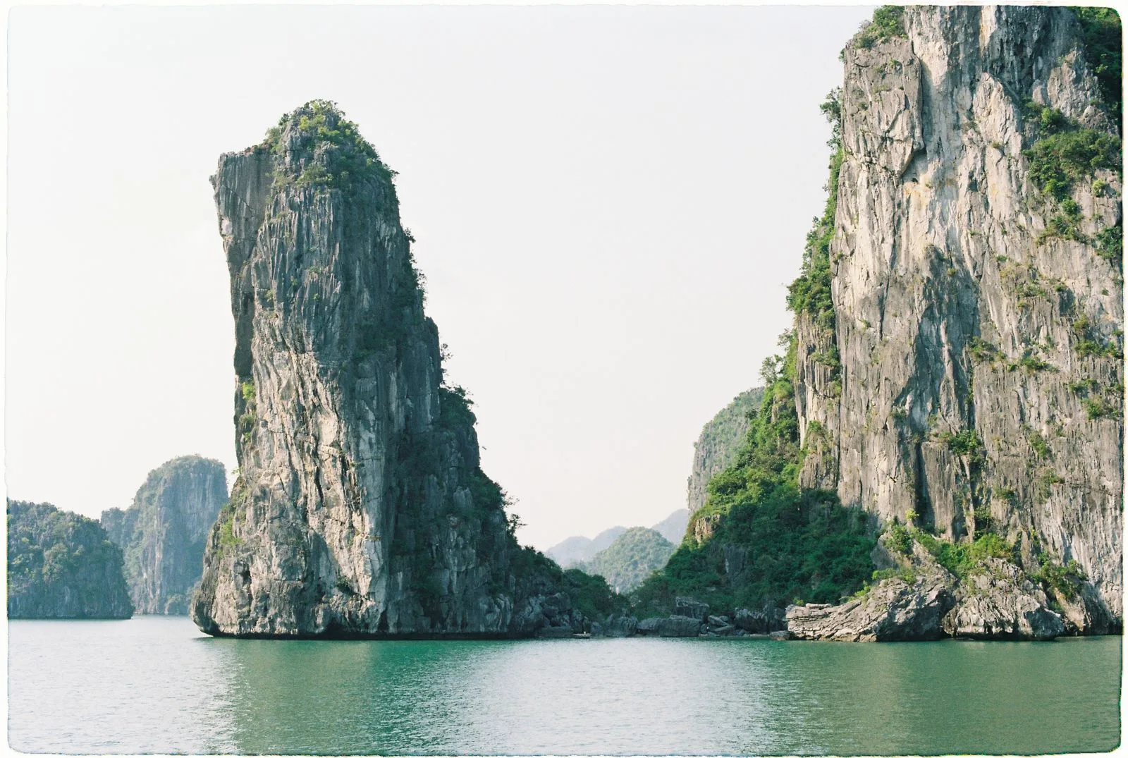 Towering limestone karst islands rising from the water in Ha Long Bay, Vietnam