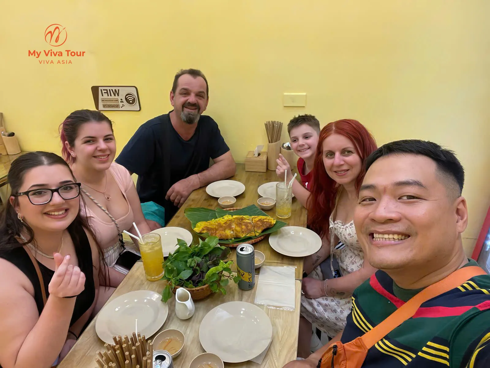Family gathered for a Hanoi dinner of grilled fish and fresh juice