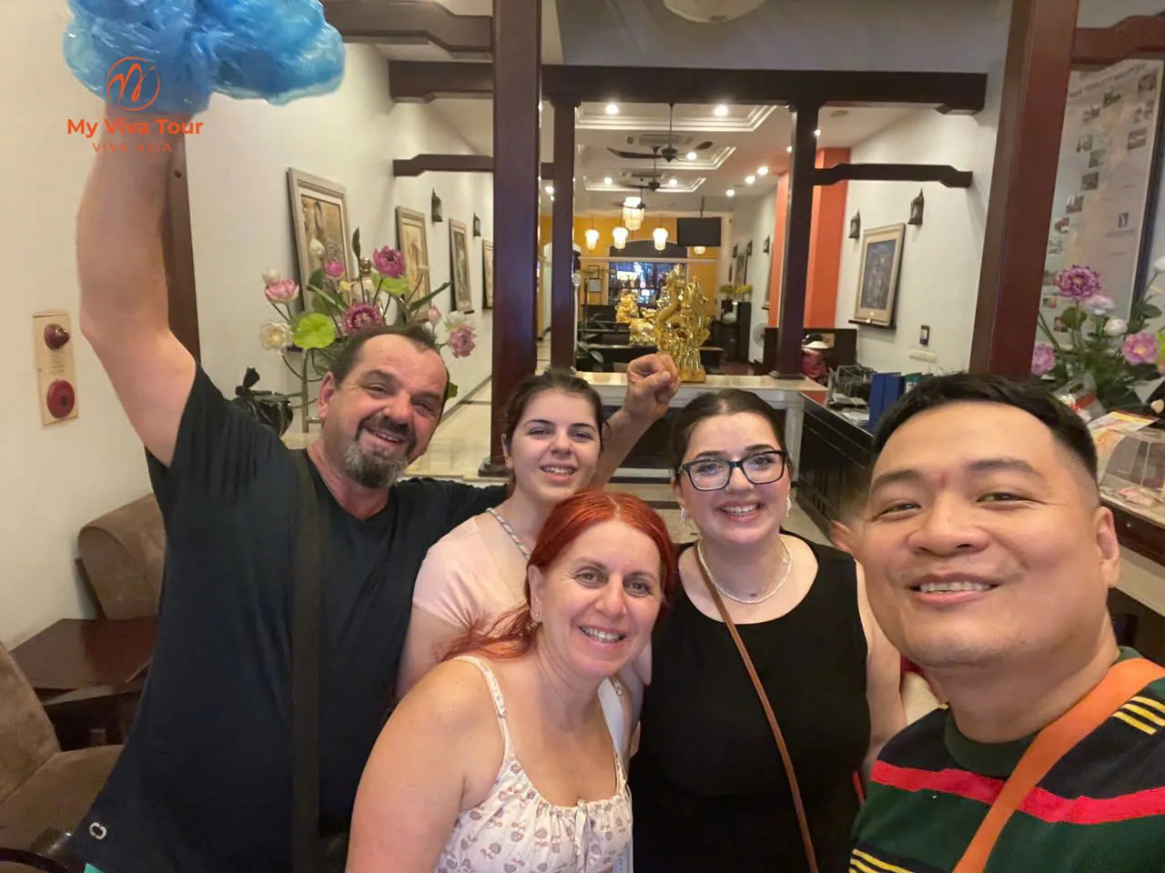 Family posing together in a Hanoi hotel lobby on arrival day