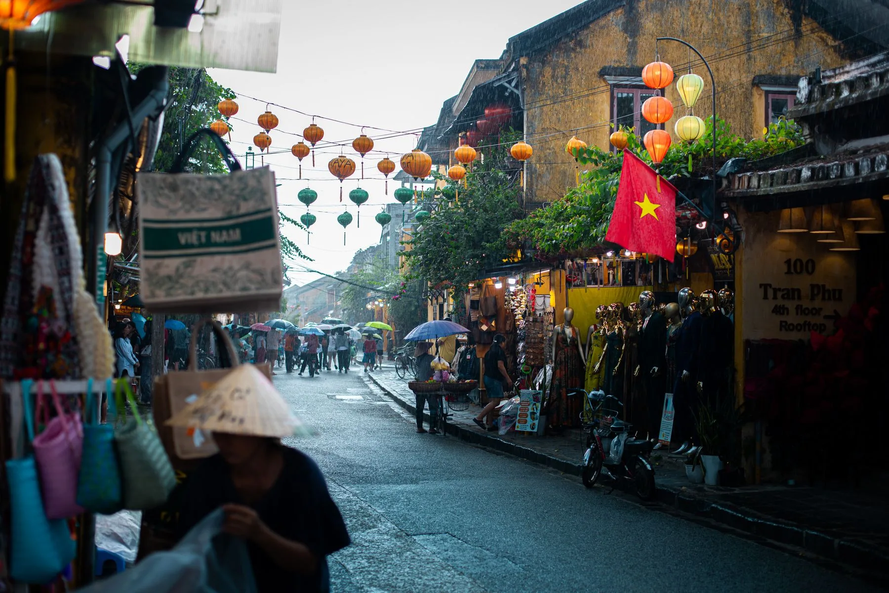 Lantern-lit street scene in Vietnam with travellers exploring in the evening
