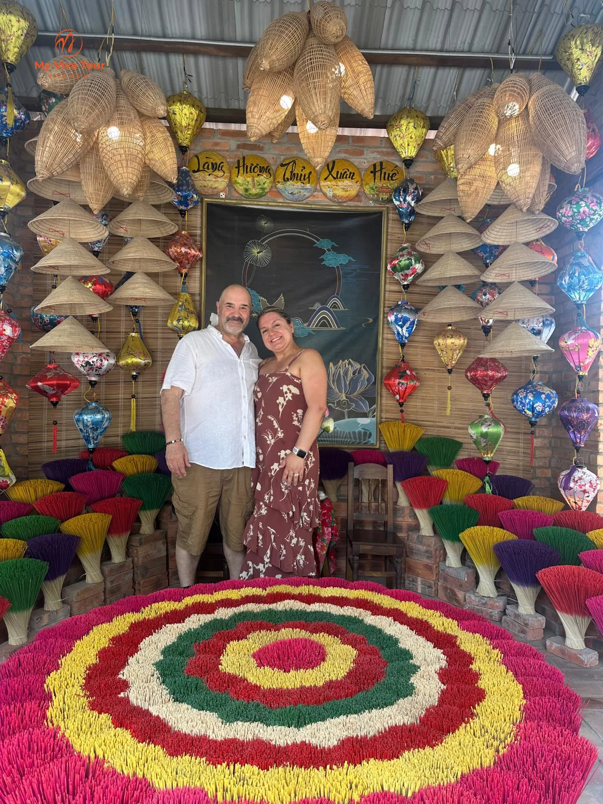 Couple among colourful incense sticks at Thuy Xuan Incense Village, Hue