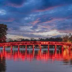 Vietnam visa for UK and EU citizens — the red Huc Bridge at sunset over Hoan Kiem Lake, Hanoi