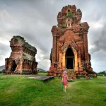 Solo traveller exploring ancient temple ruins on a solo trip to Vietnam