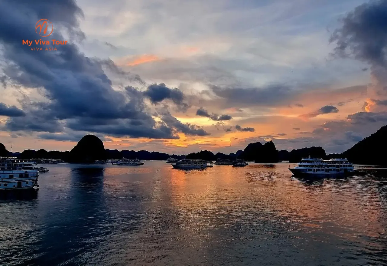 Teresa Bellis Vietnam anniversary trip — sunset over Ha Long Bay cruise boats and limestone karsts