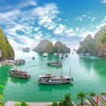 Vietnam tours from the UK — cruise boats among the limestone karsts of Ha Long Bay