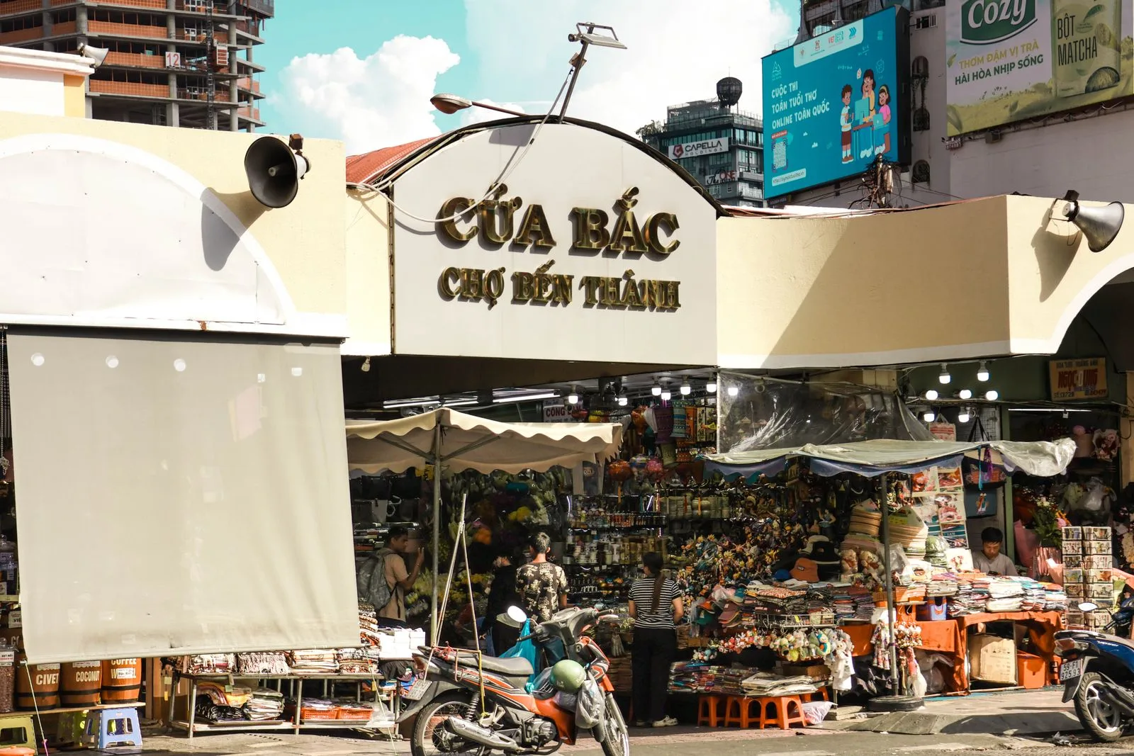 Ho Chi Minh City travel guide: the north gate of Ben Thanh Market with stalls and motorbikes