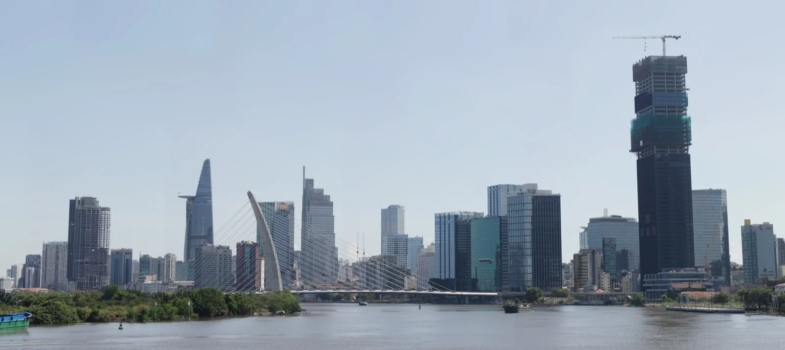 Ho Chi Minh City travel guide: the Saigon River skyline with Bitexco Tower and the Ba Son bridge