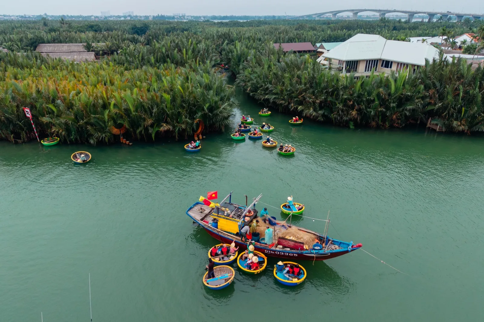 Round basket boats on the water beside the water coconut palms at Cam Thanh near Hoi An