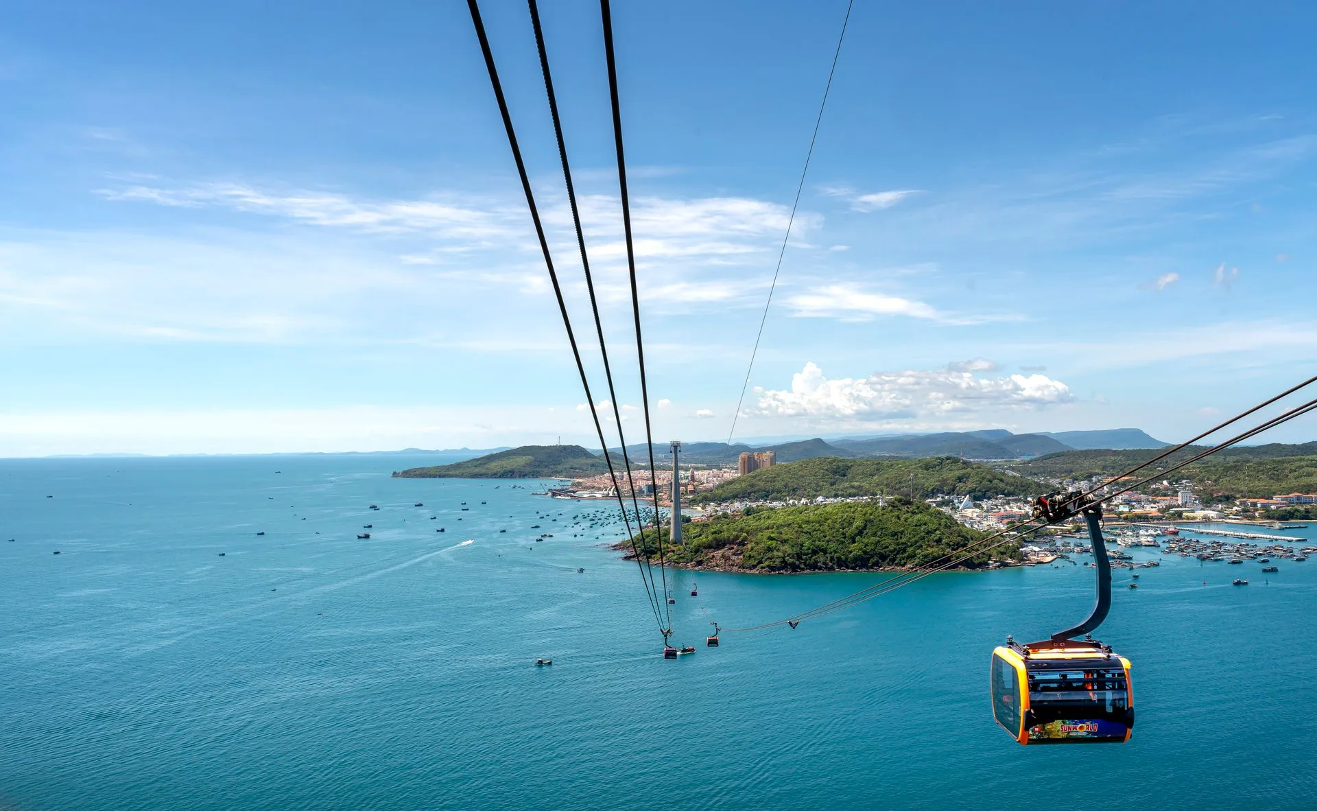 Cable car gondola crossing the sea to Hon Thom above fishing boats off southern Phu Quoc