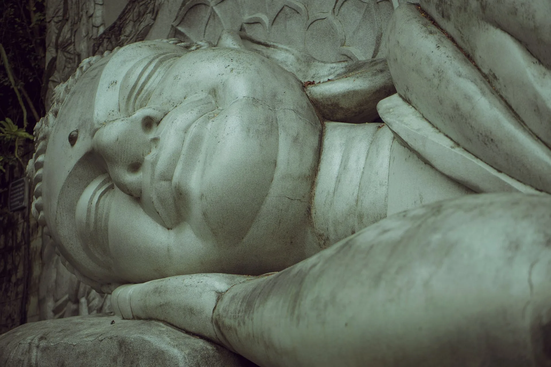 Close-up of the white stone reclining Buddha at Long Son Pagoda in Nha Trang, head resting on one hand
