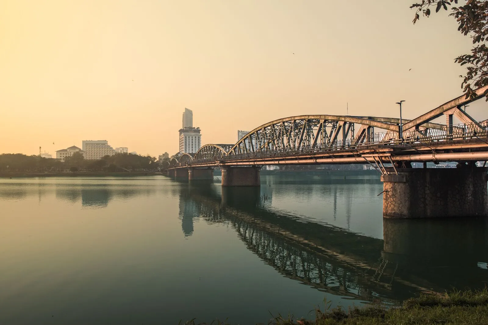 Truong Tien Bridge and its steel arches reflected in the Perfume River in Hue at sunset