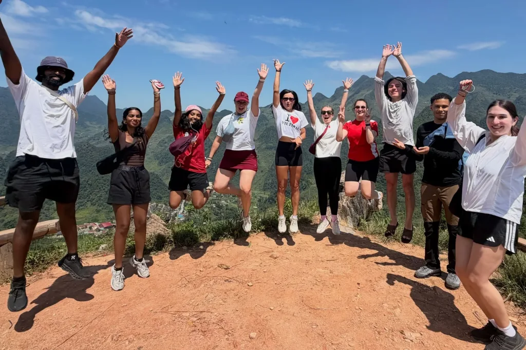 Anna Bright (fifth from left) joins a group of international travelers exploring the Ha Giang Loop by motorbike.