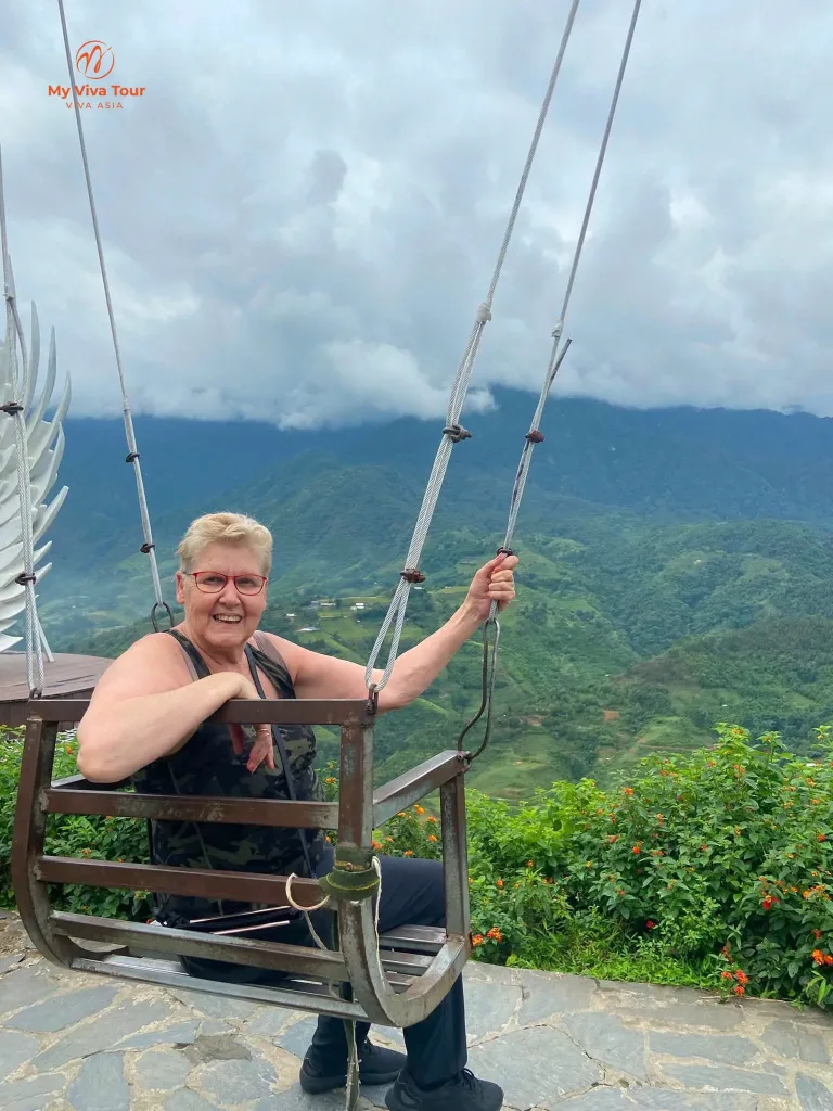 Month in Vietnam — Missy on a swing above the green Sapa valley under low cloud