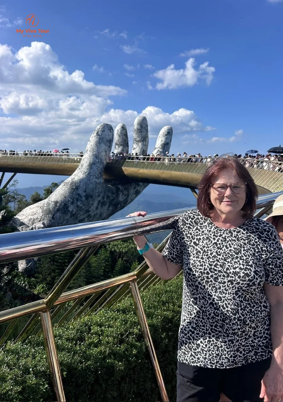 Carmen at the Golden Bridge with its giant stone hands, Ba Na Hills near Da Nang