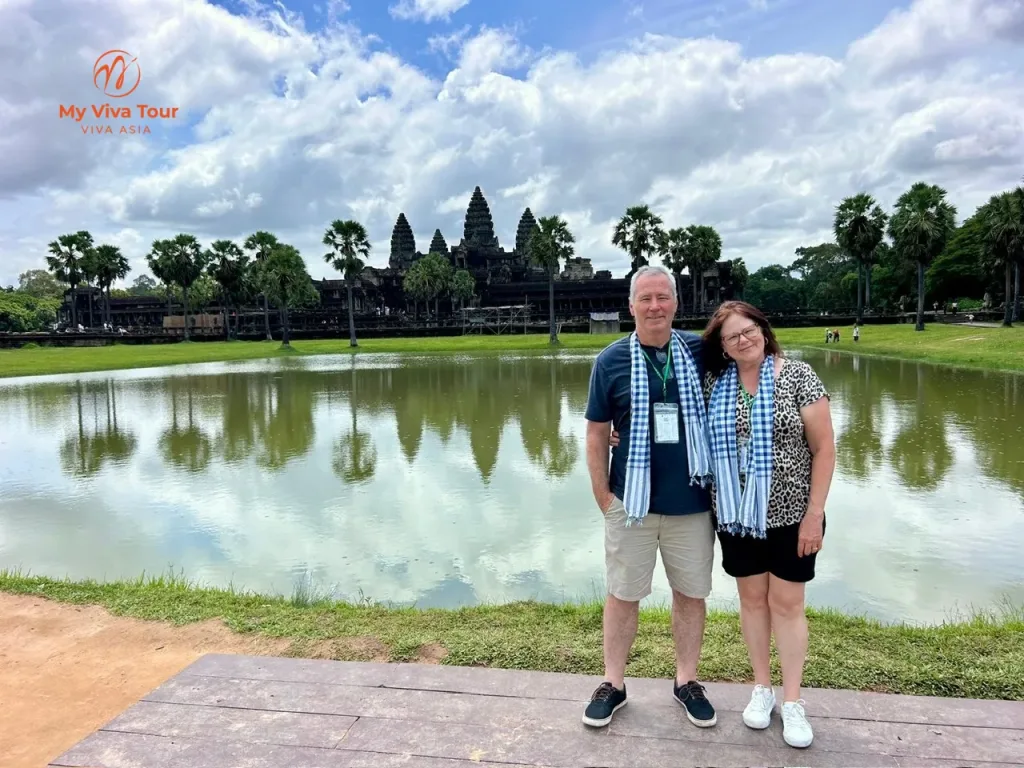 Vietnam and Cambodia trip — two Australian travellers in krama scarves beside the reflecting pond at Angkor Wat