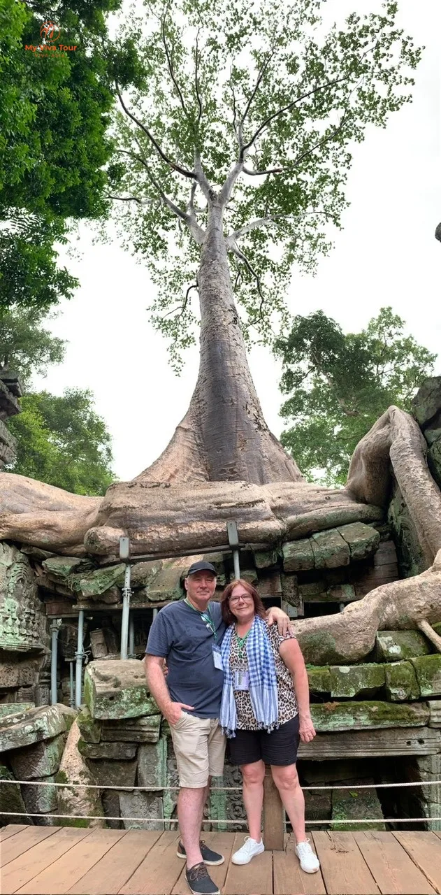 Carmen and her travel companion under the giant silk-cotton tree roots at Ta Prohm, Siem Reap