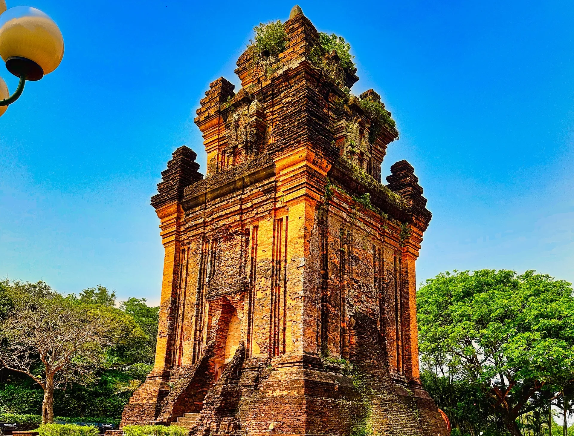 Nhan Tower, a weathered Cham brick tower in Tuy Hoa under a blue sky