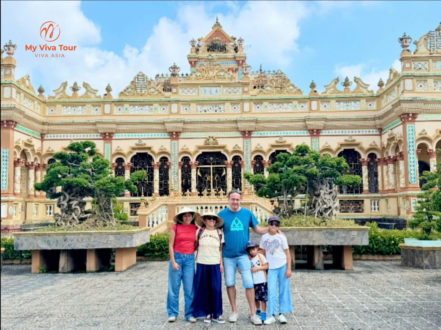 Family in front of Vinh Trang Pagoda in My Tho, Mekong Delta